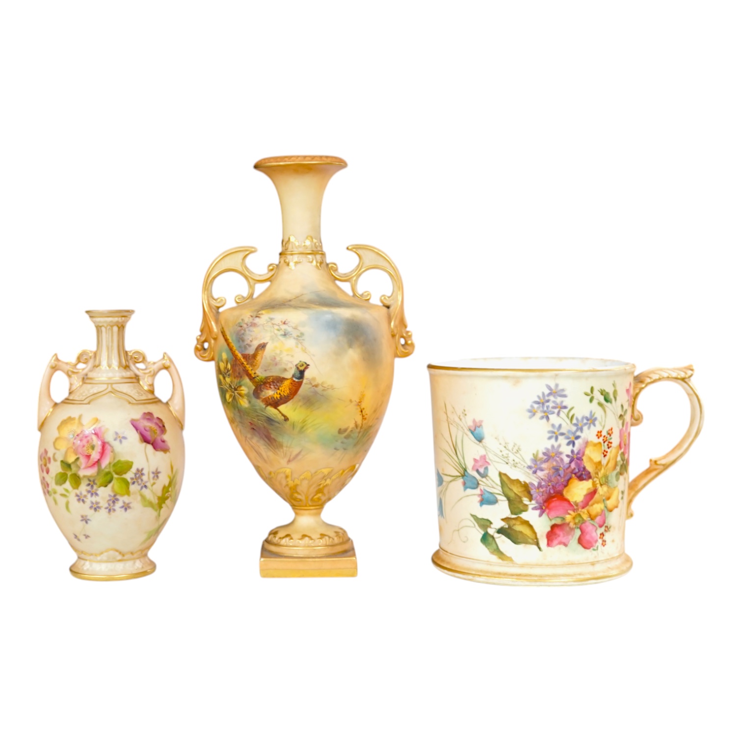 Three pieces of Royal Worcester; a mug, 11.5cm high, and two vases, tallest 22.5cm. Condition - good.